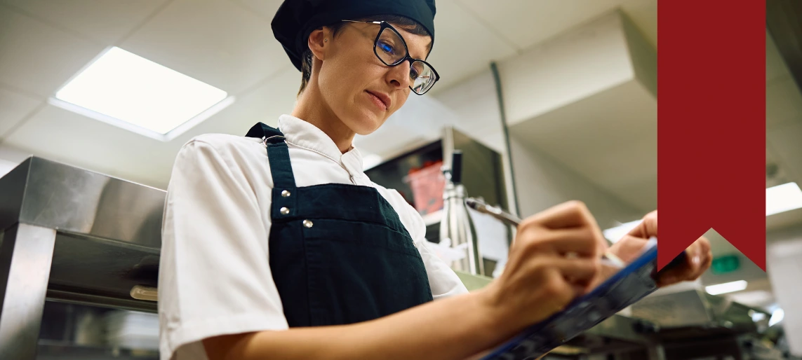 Cannabis kitchen manager reviewing utility readiness checklist to verify electrical, plumbing, and ventilation requirements for a compliant production facility with Aldevra.