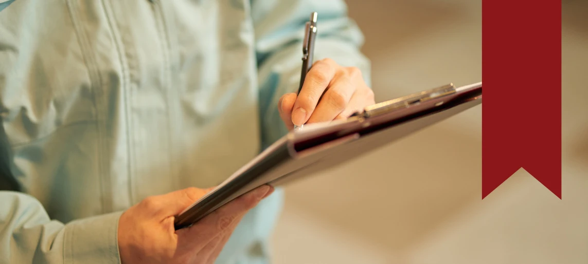 Cannabis kitchen manager reviewing inspection checklist to prepare for health department and regulatory approval with Aldevra.