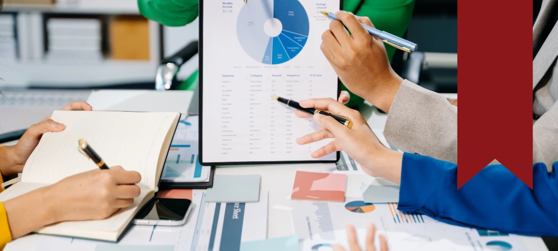 Community shared kitchen leadership team reviewing financial reports and operational performance metrics for sustainable facility management.