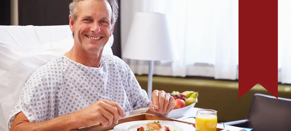 Hospital patient enjoying a nutritious meal, representing healthcare foodservice efforts to balance flavor, dietary compliance, and patient satisfaction.