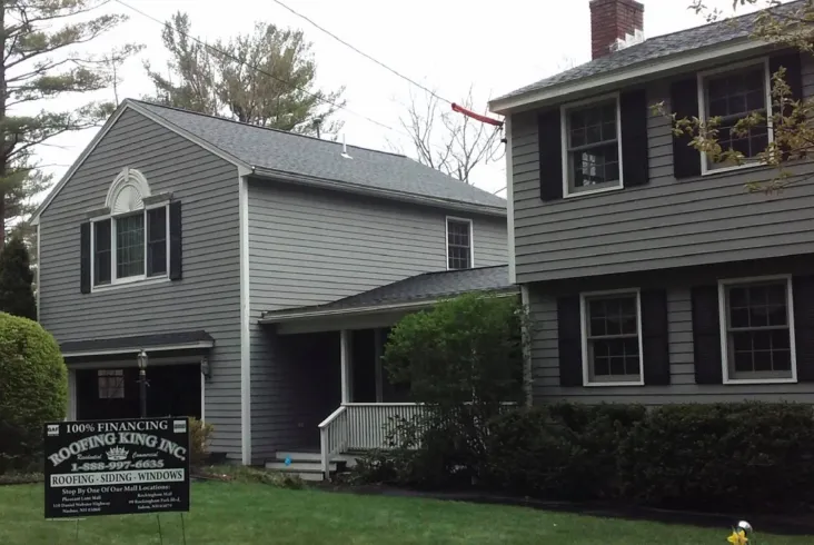 Spacious house with a well-kept lawn and clear sky backdrop.