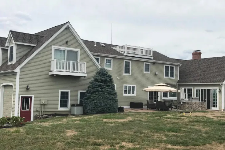 Large home with a balcony and spacious backyard.