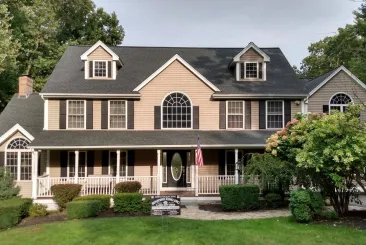 Spacious home with a dark shingle roof in Chelsea, MA.