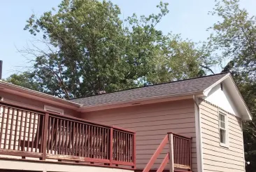 House with a new roof and a wooden deck in Natick, MA.