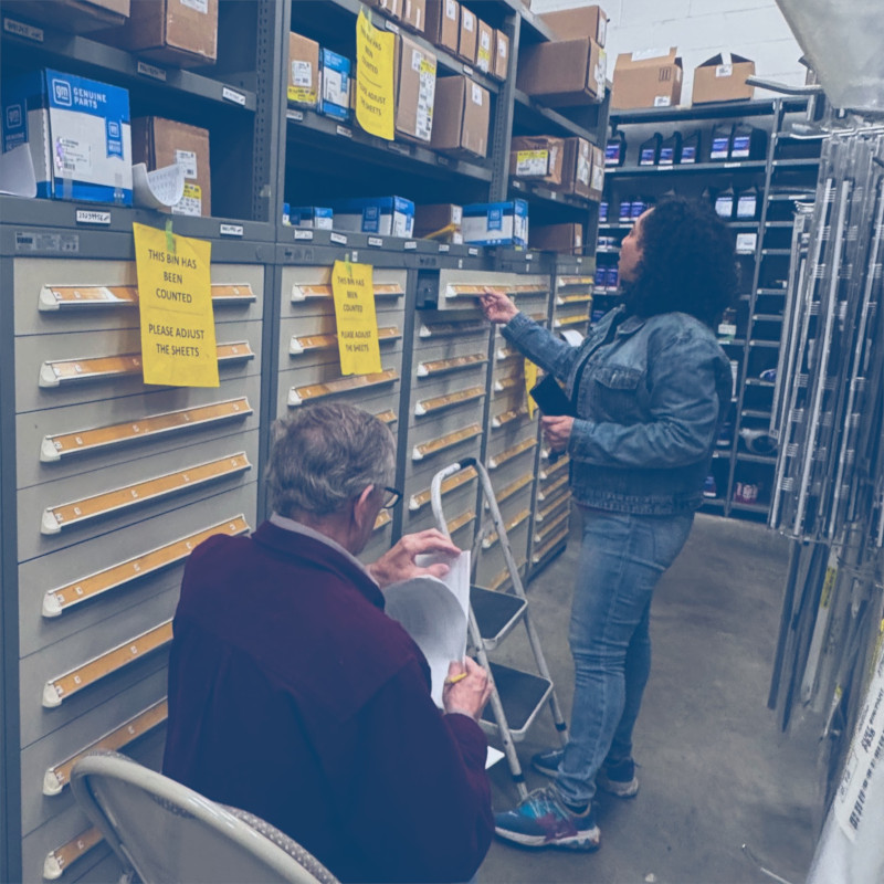 Pro-Count employees counting car parts at an automotive dealership.