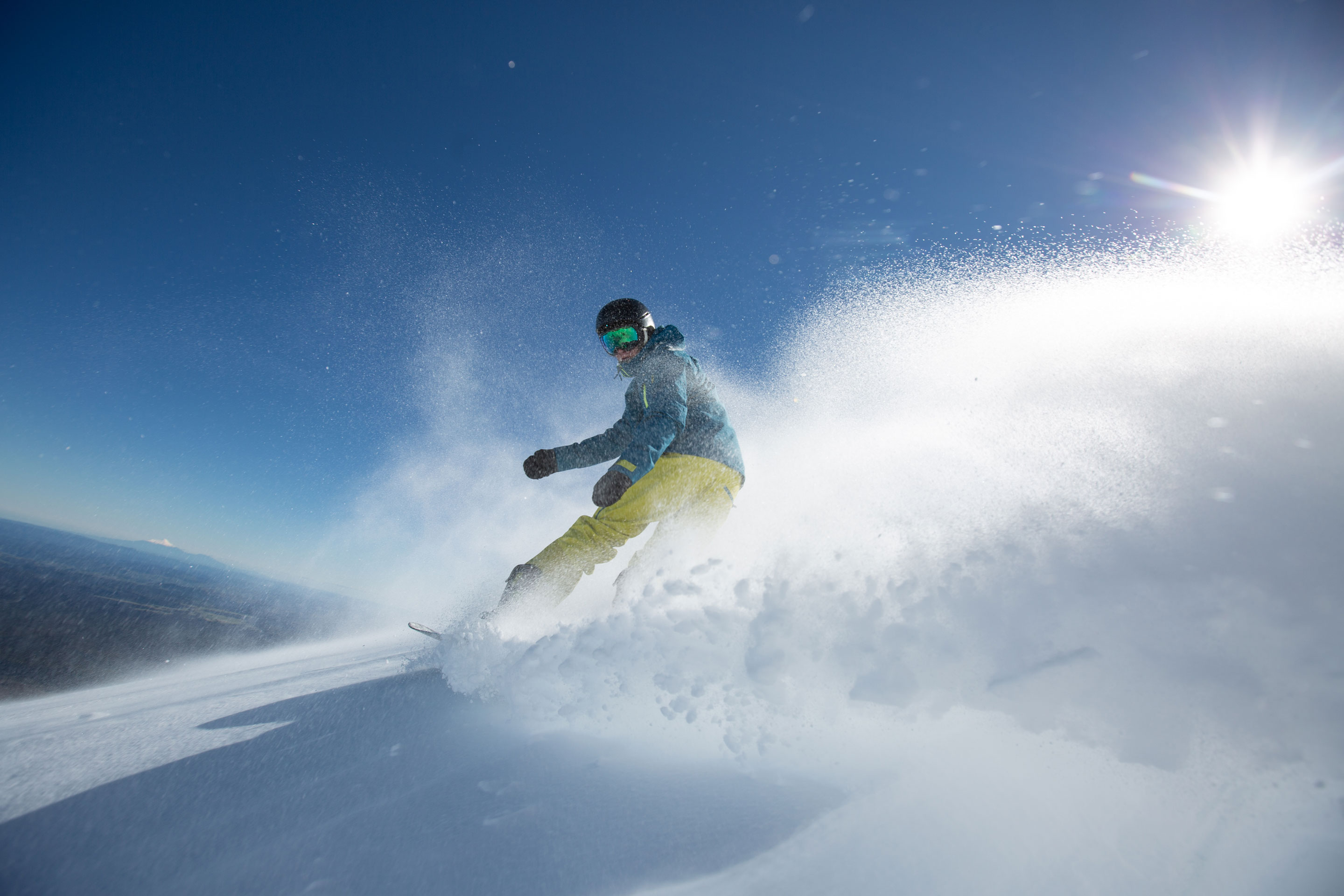 Skier carving a turn at Tūroa Ski Area on Mt Ruapehu under blue sky