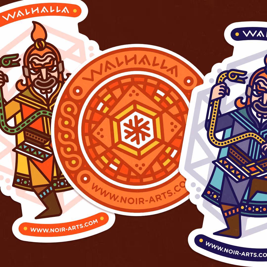 Punainen ja oranssi pyöreä Wallhalla-tarra, jossa keskellä lumihiutalekuvio ja kehällä tekstit Wallhalla ja www.noir-arts.com.