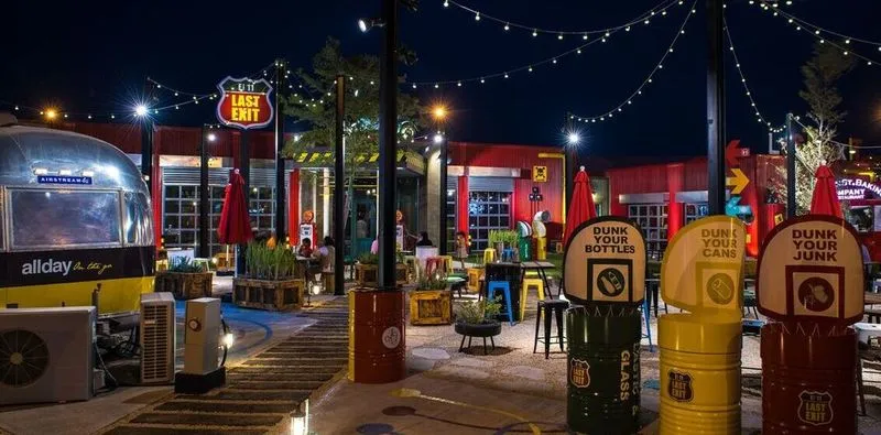 night view of an outdoor dining at last Exit with shipping containers and string lights