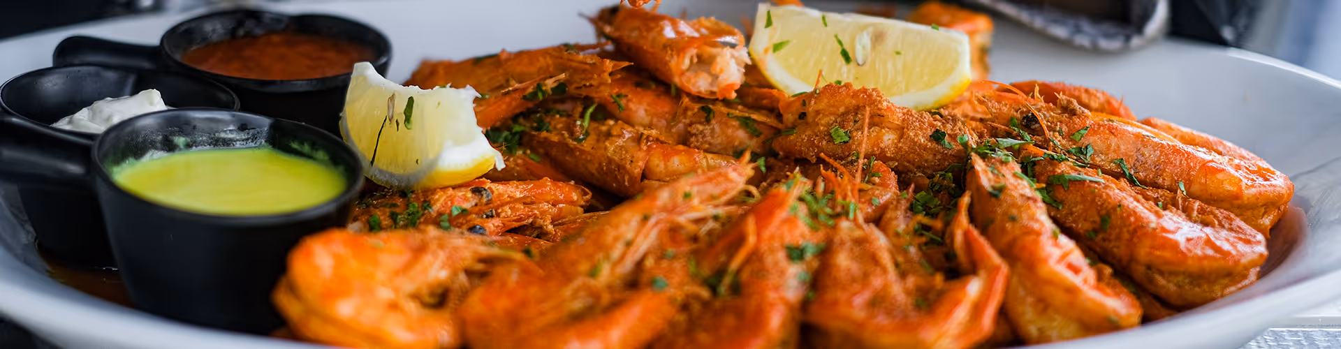 cooked shrimp or prawns garnished with fresh parsley and a lemon wedge