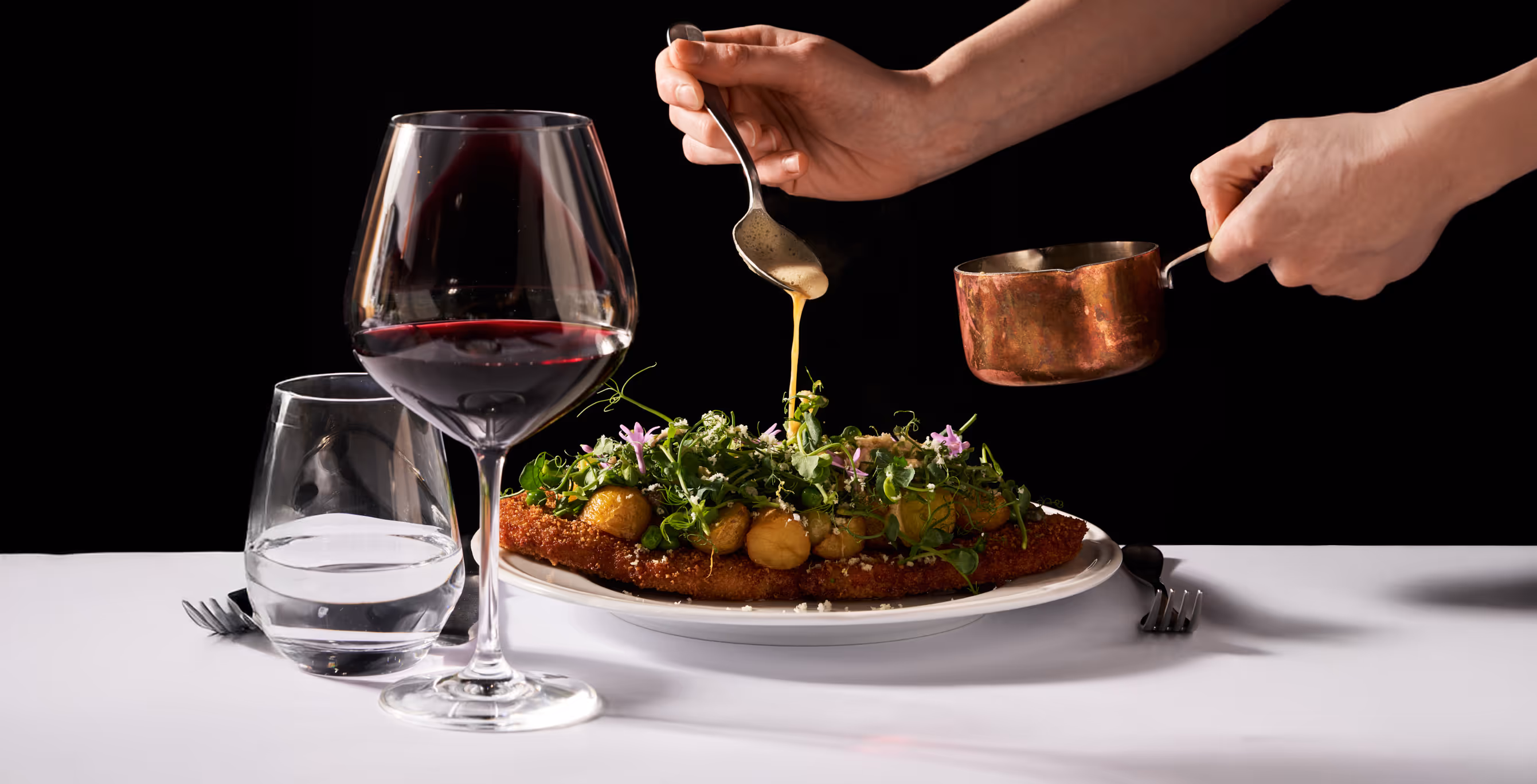 Wienerschnitzel “ART” of Danish free-range pork with peas, browned butter, lemon, and horseradish served with a glass of red wine