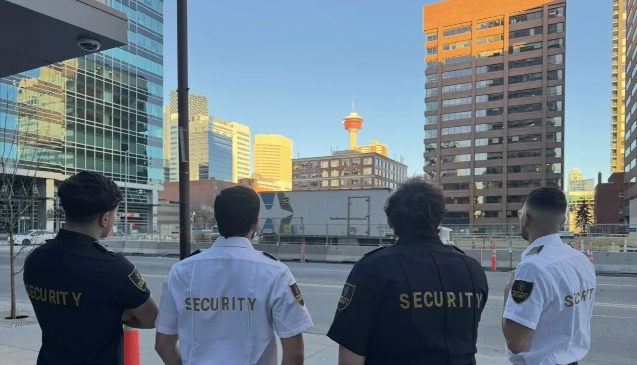 Four uniformed Guard Tower Security team members standing together.