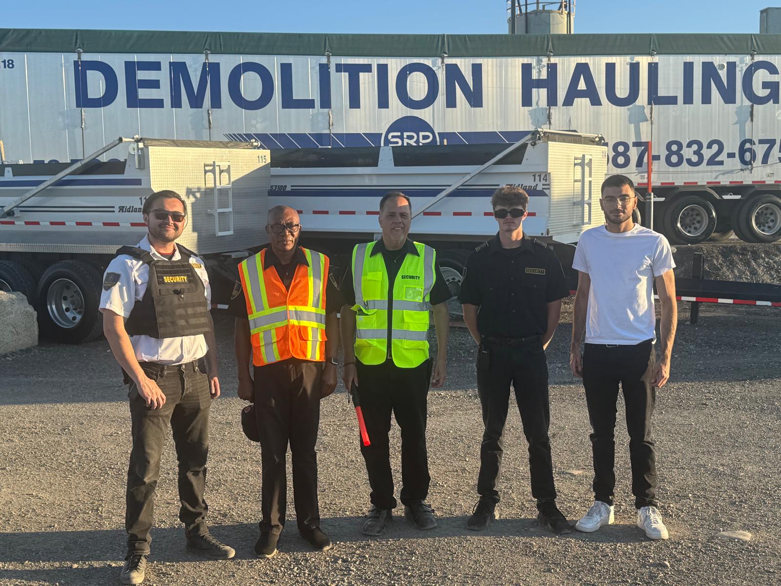 Four uniformed Guard Tower Security team members standing together in Calgary.