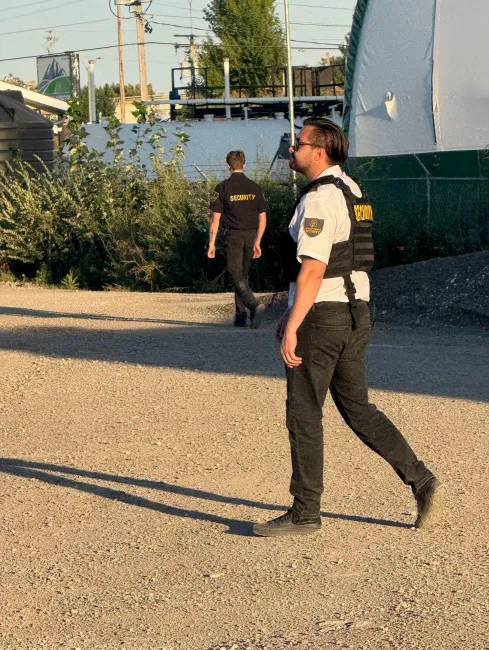 Security guard documenting patrol activity with detailed inspection and checklist records.