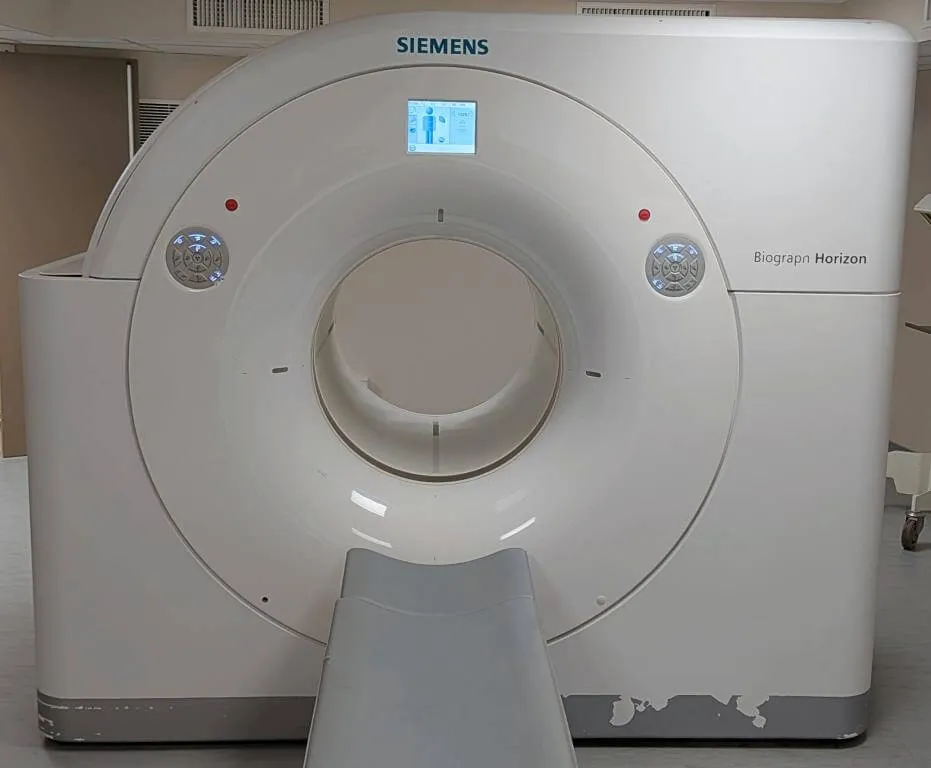 Siemens Biograph Horizon medical imaging machine with patient bed in a clinical room.
