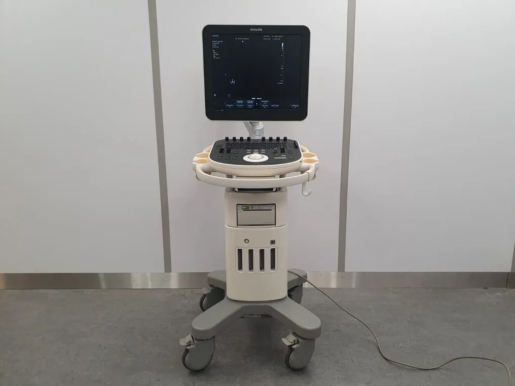 Philips ultrasound machine on wheels with control panel and monitor displaying a black screen with white text.