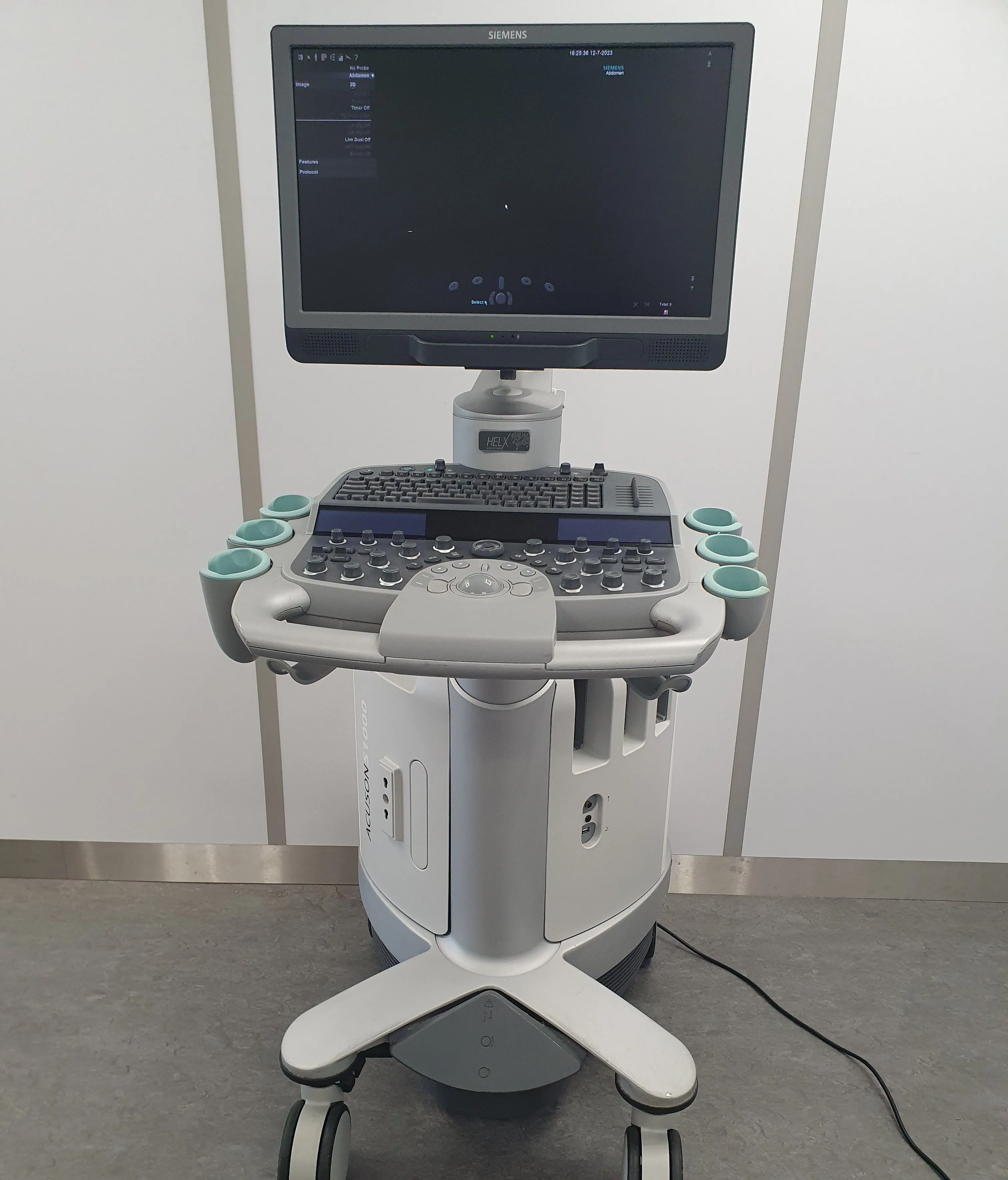 Siemens Acuson ultrasound machine with monitor, keyboard, control panel, and probe holders.
