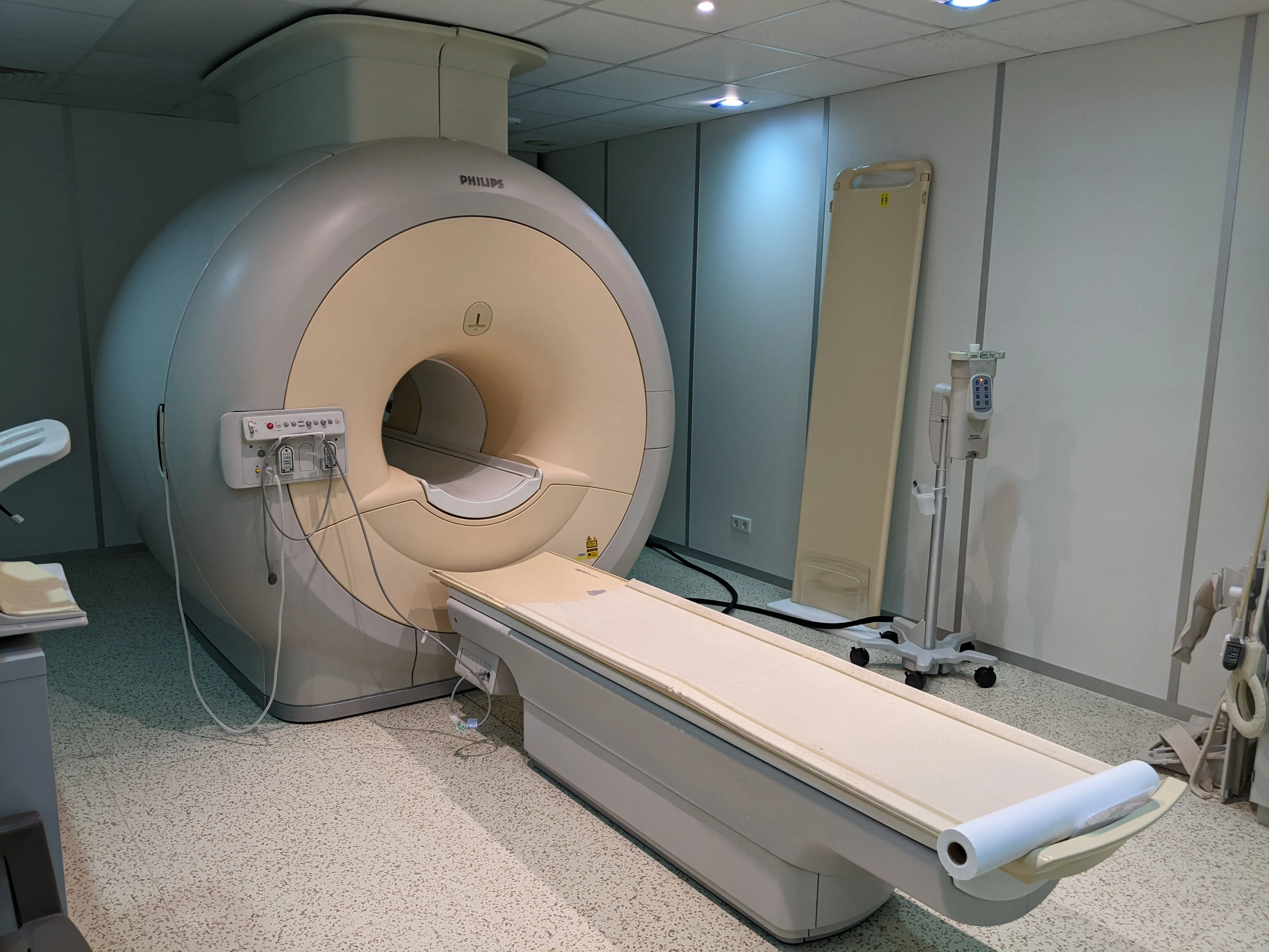 Philips MRI machine with patient bed extended in a clean medical imaging room.