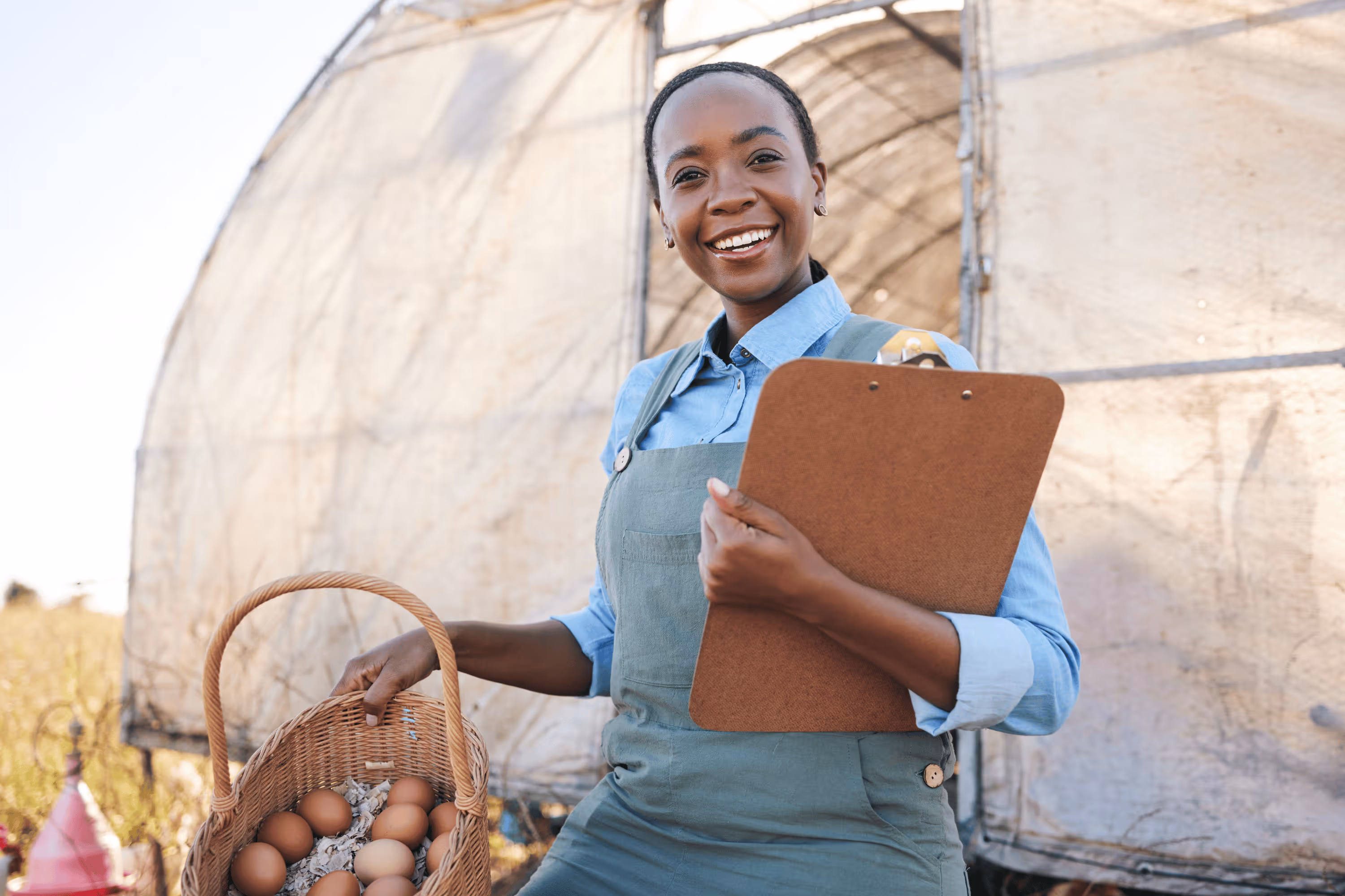 A happy woman holding a basket with eggs