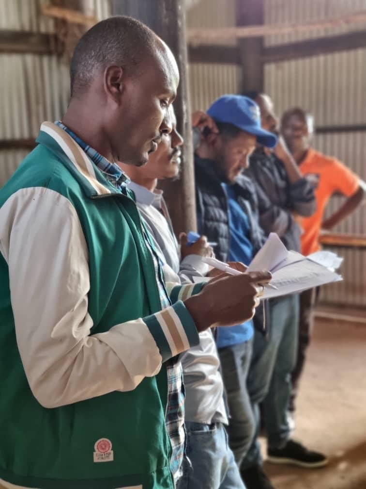 Staff on a farm with papers
