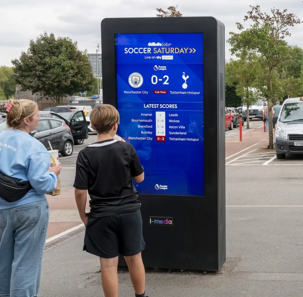 A digital screen showing Premier League fixtures at a motorway services.