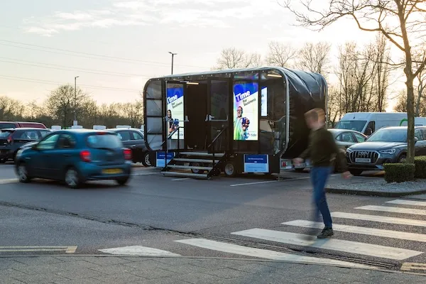 An experiential digital screen set-up in a motorway service area carpark.