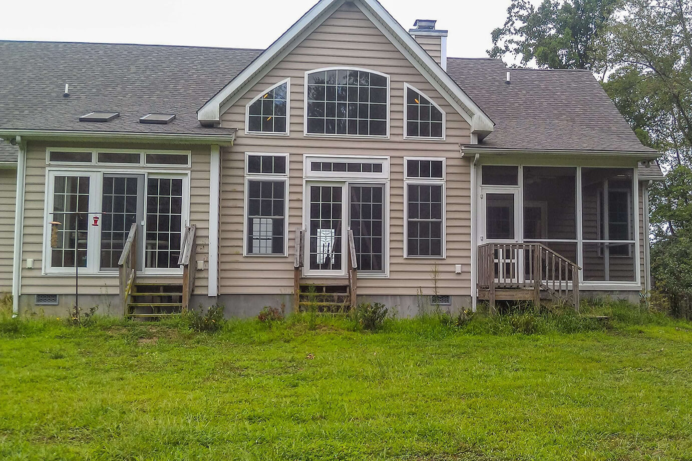Back of house before back deck construction by Lewis Built