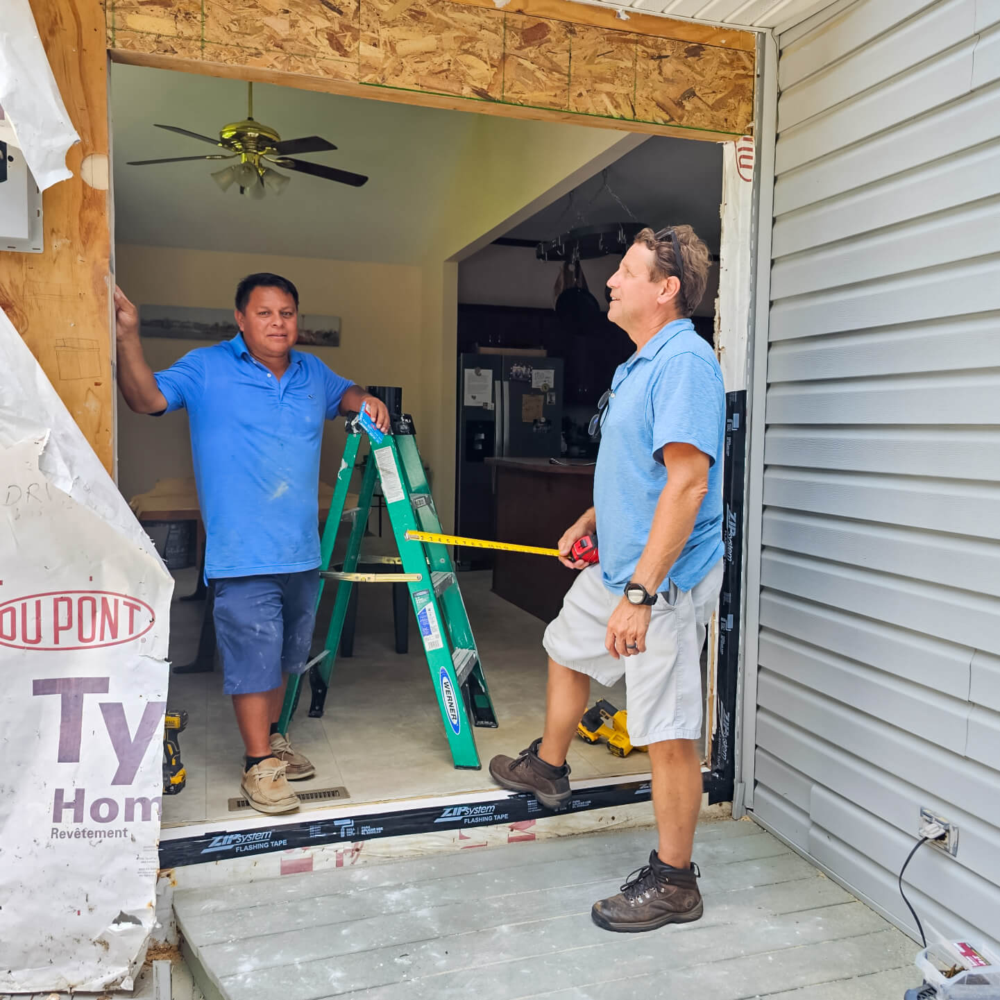 Darrell Lewis of Lewis Built doing a measurement for a home renovation 
