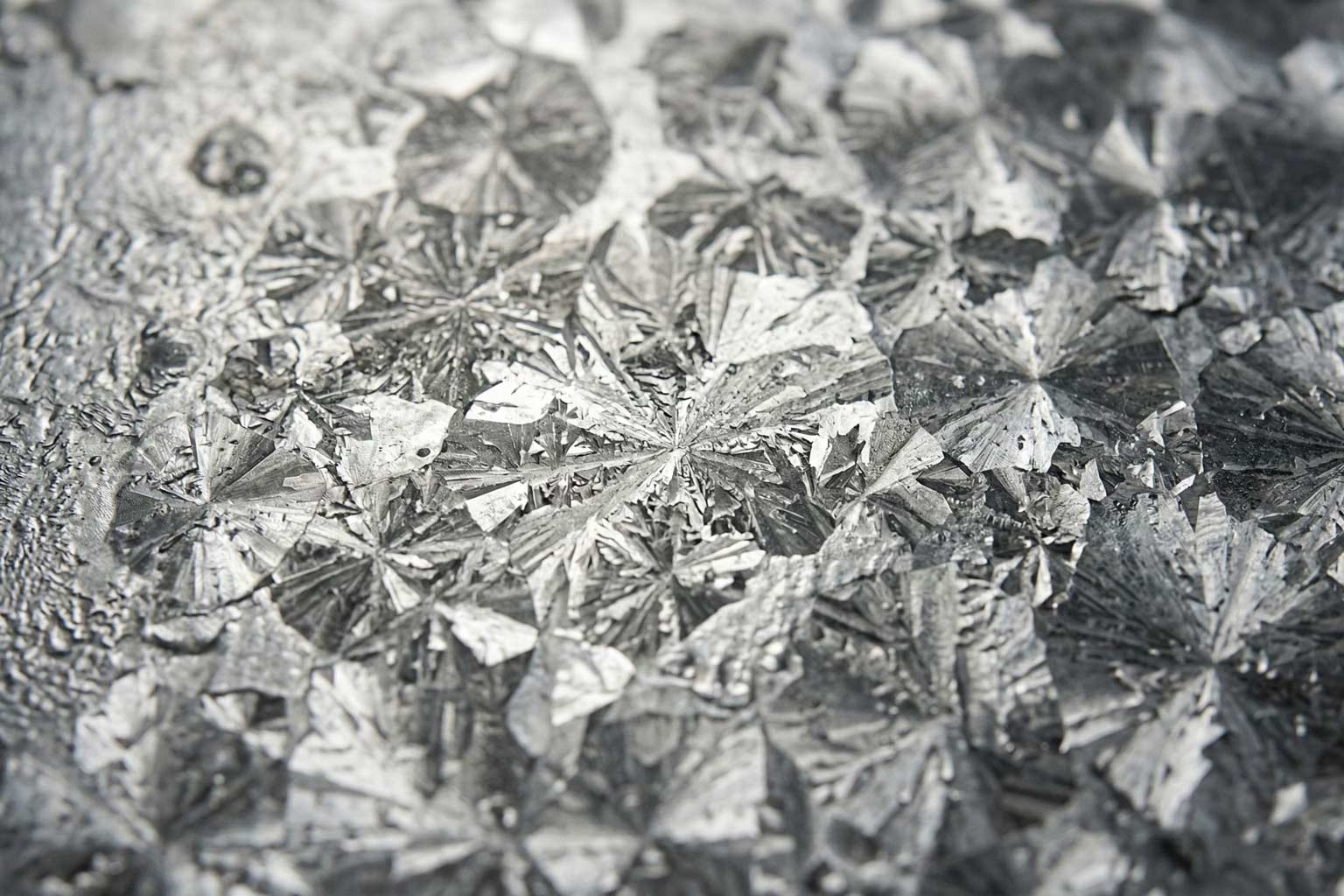 Close up of hot dip galvanized steel surface showing spangle pattern and coating texture