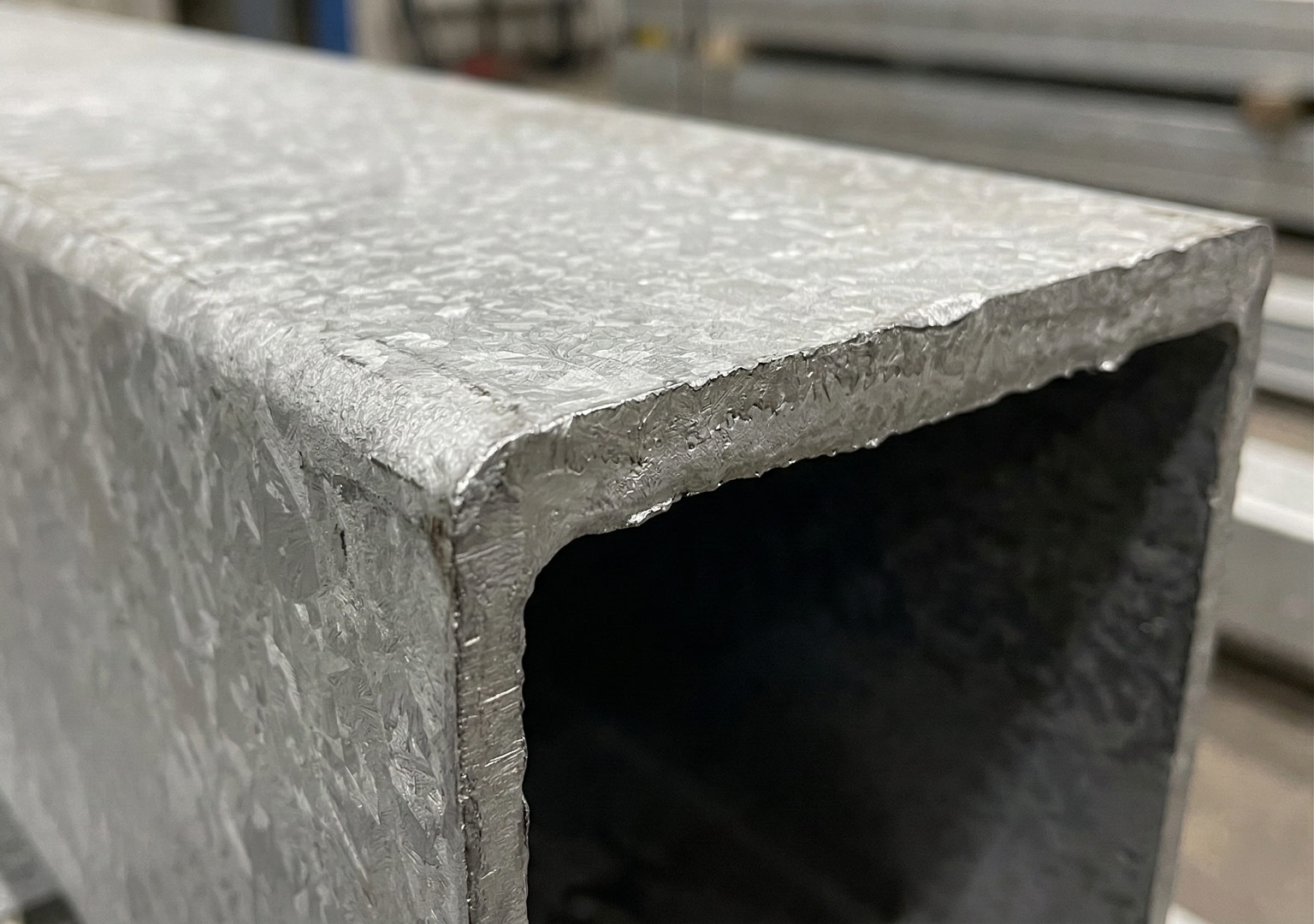 Hot dip galvanized steel surface showing heavy zinc coating thickness