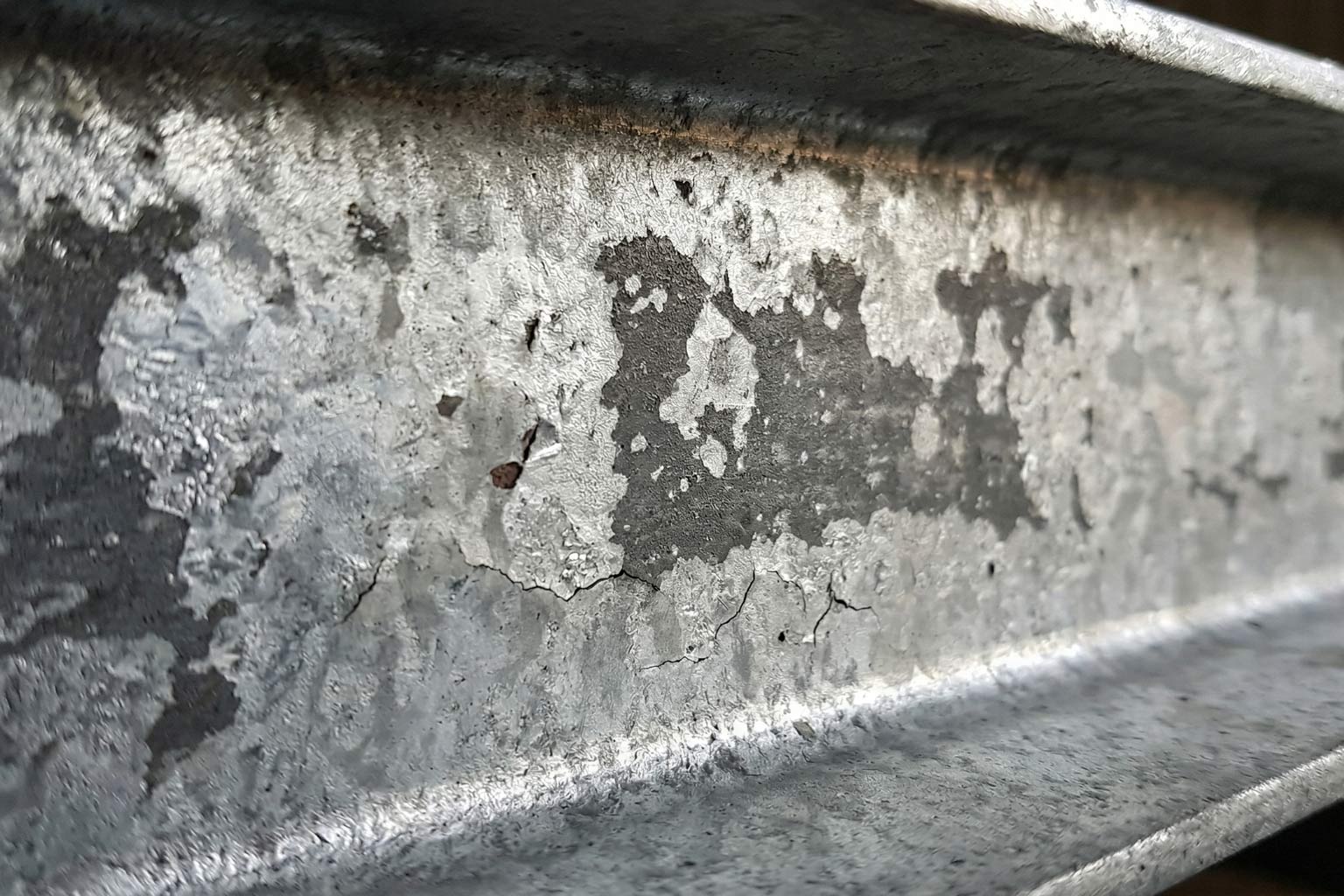 Close up of thinner hot dip galvanized zinc coating on structural steel surface