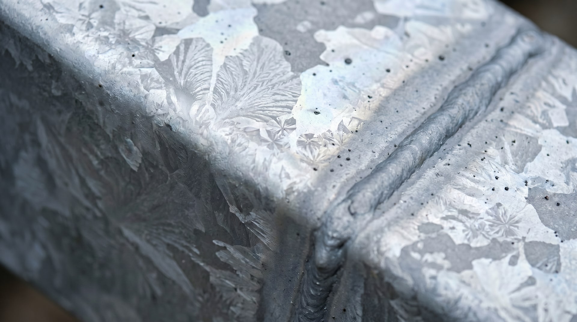 Hot dip galvanized steel surface showing natural finish variations and texture