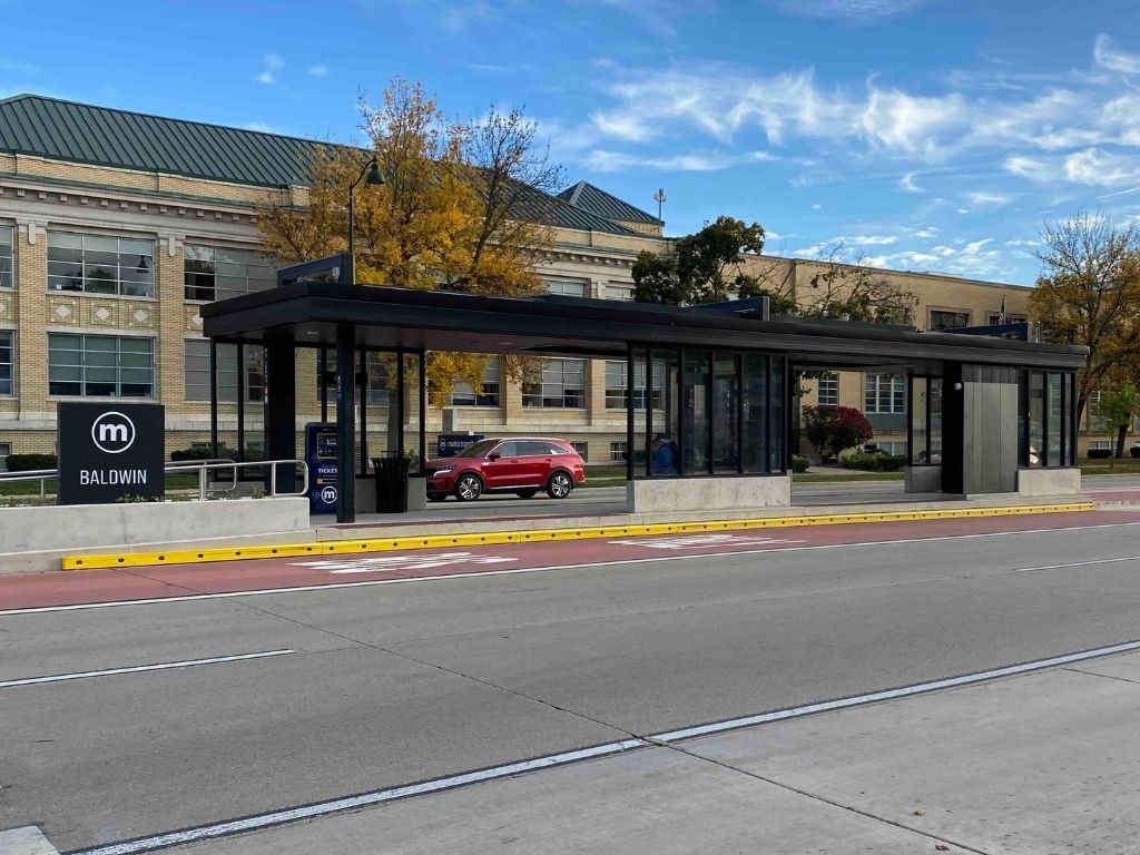 Bus rapid transit station featuring hot-dip galvanized and painted tube steel construction along East Washington Avenue