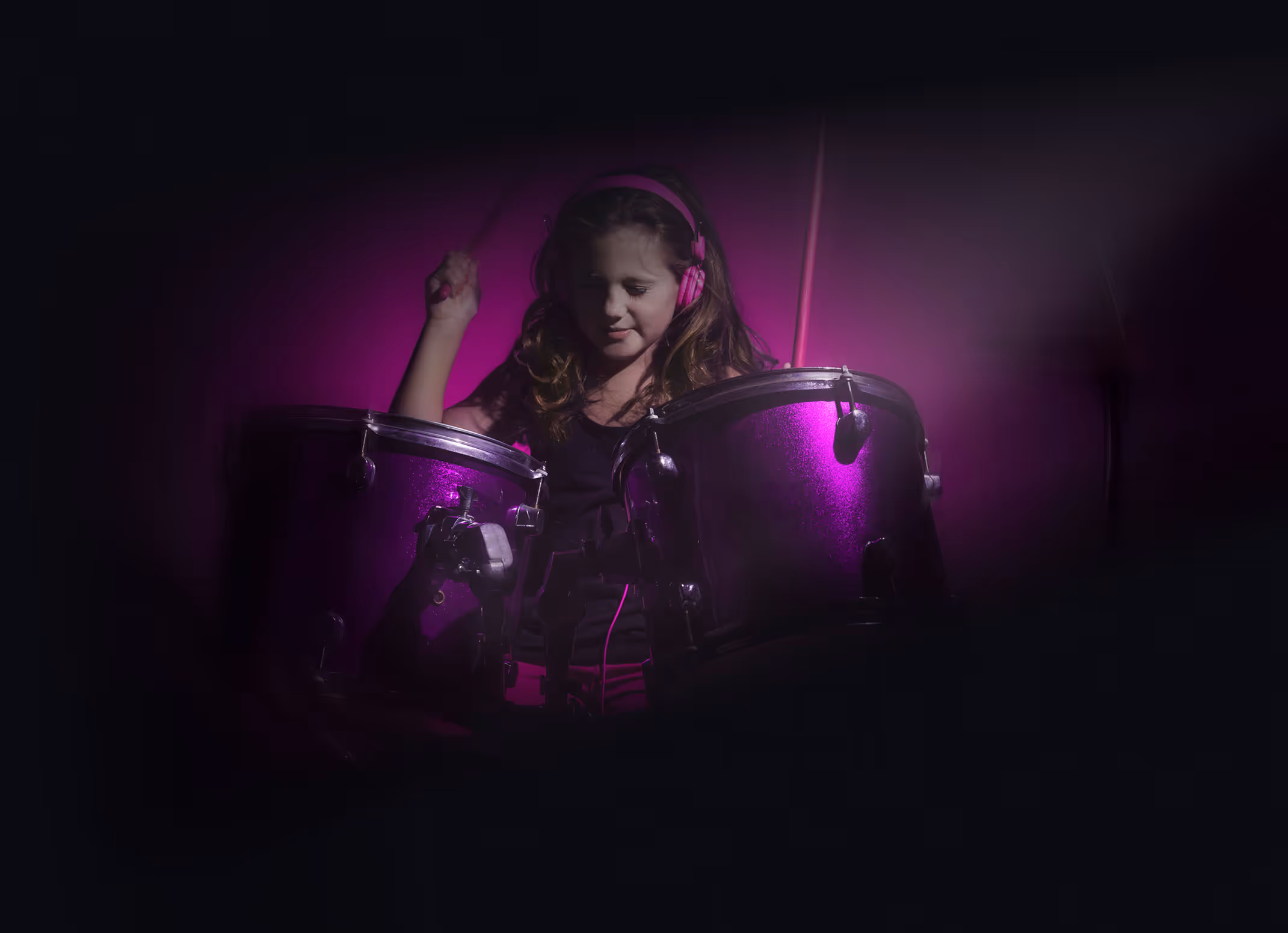 A young girl playing the drums