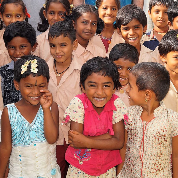 A group of children gather for a photograph