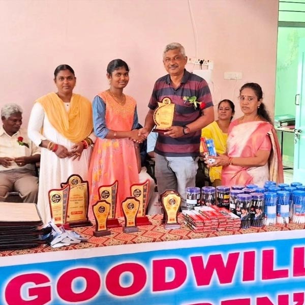 Representatives of Goodwill Children's Home present an award at a ceremony