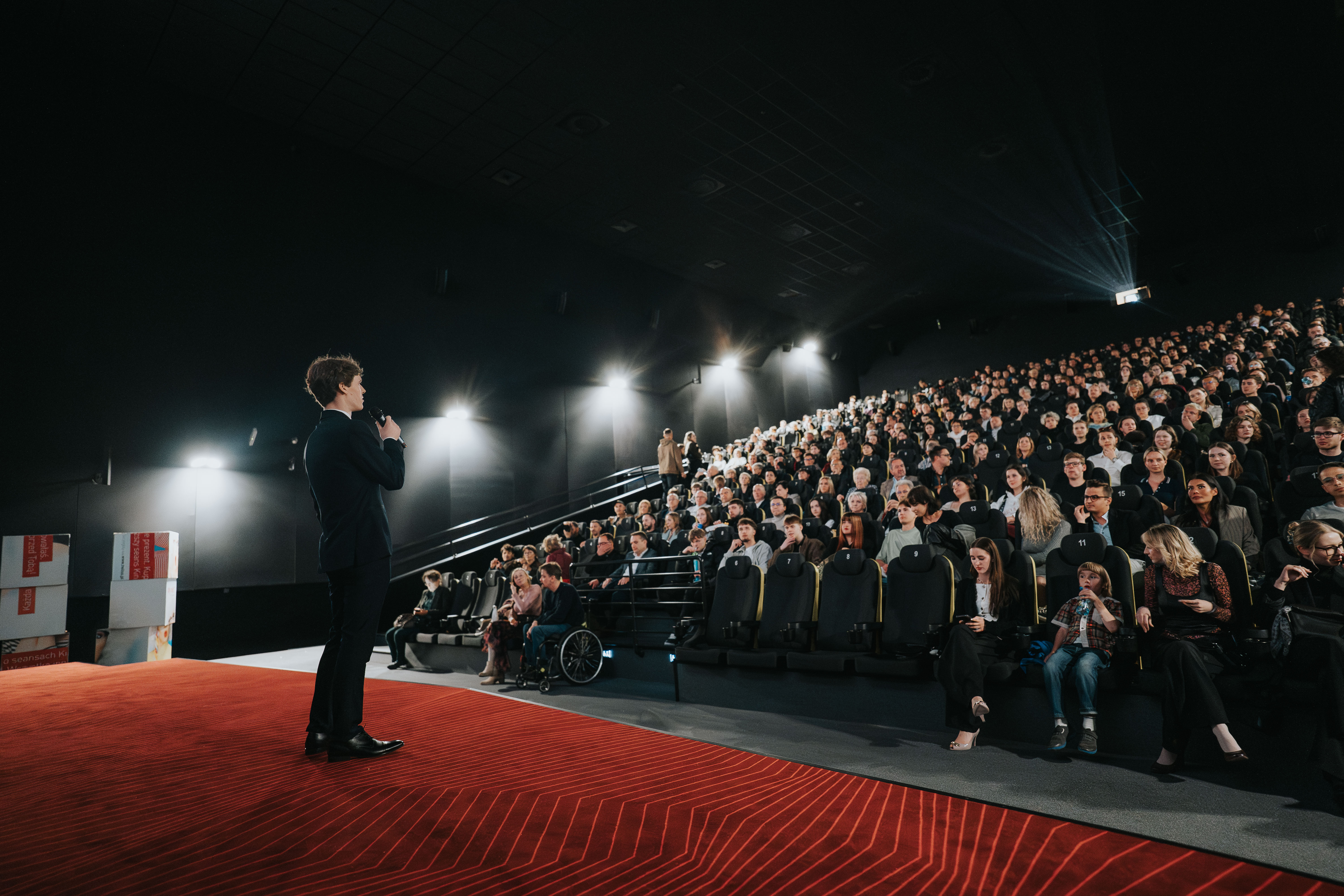 Filmmaker in a cinema talking to the crowd