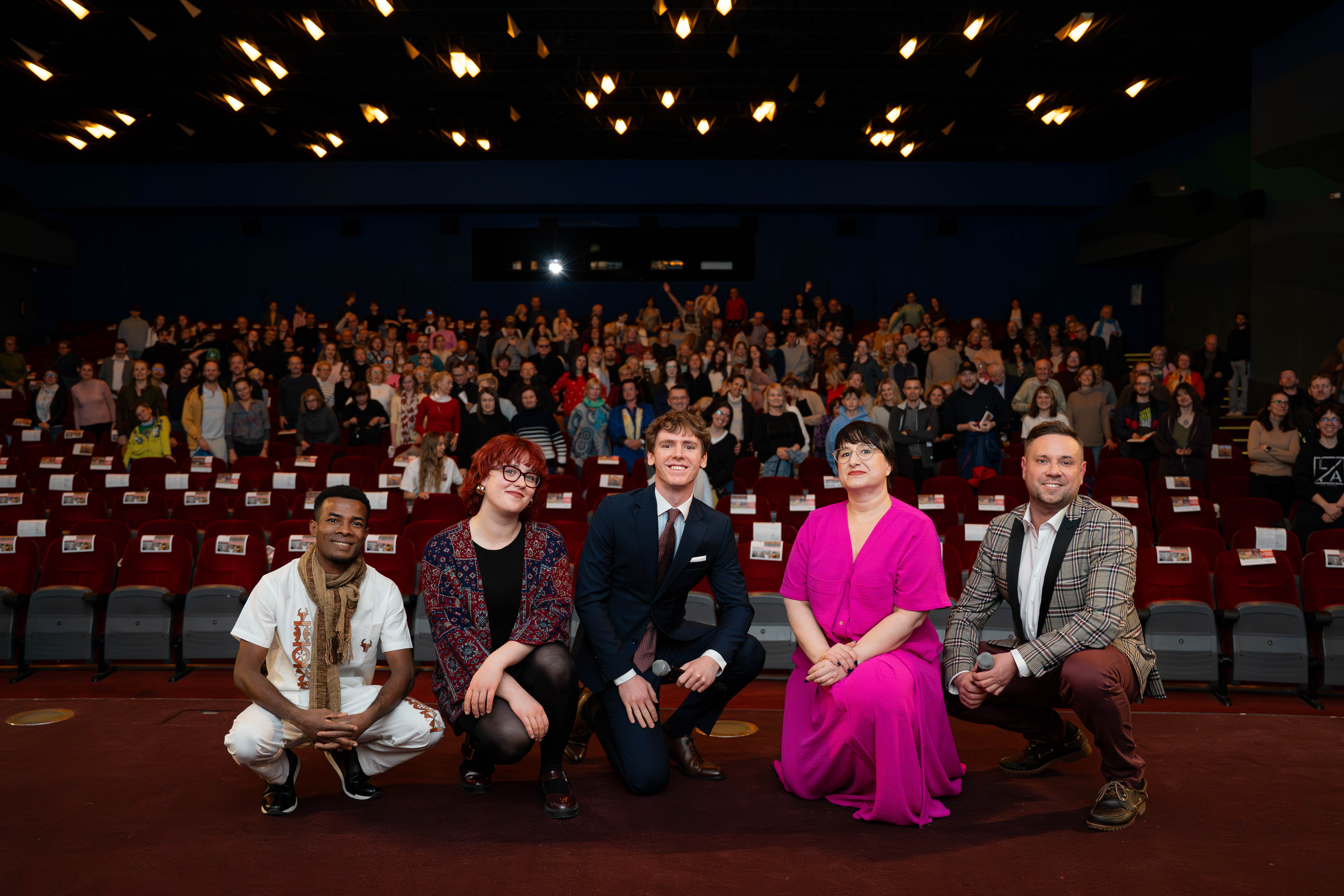 Filmmaker with the viewers in a cinema