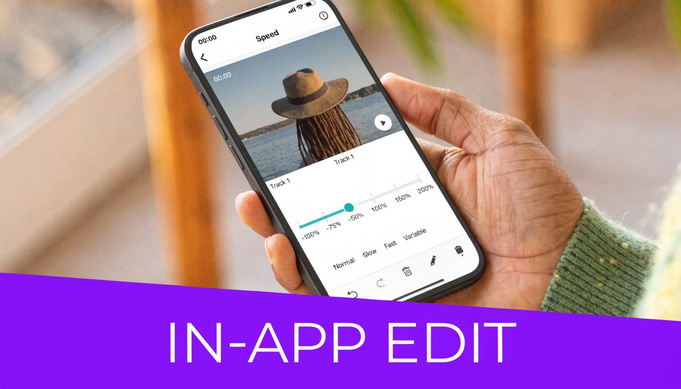 A close-up of a person holding a smartphone showing an in-app video speed editing interface.