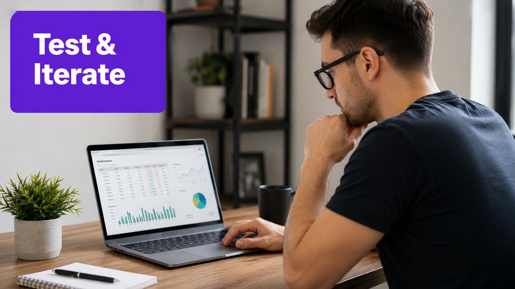 A focused man wearing glasses analyzes digital marketing performance data on a laptop screen while working