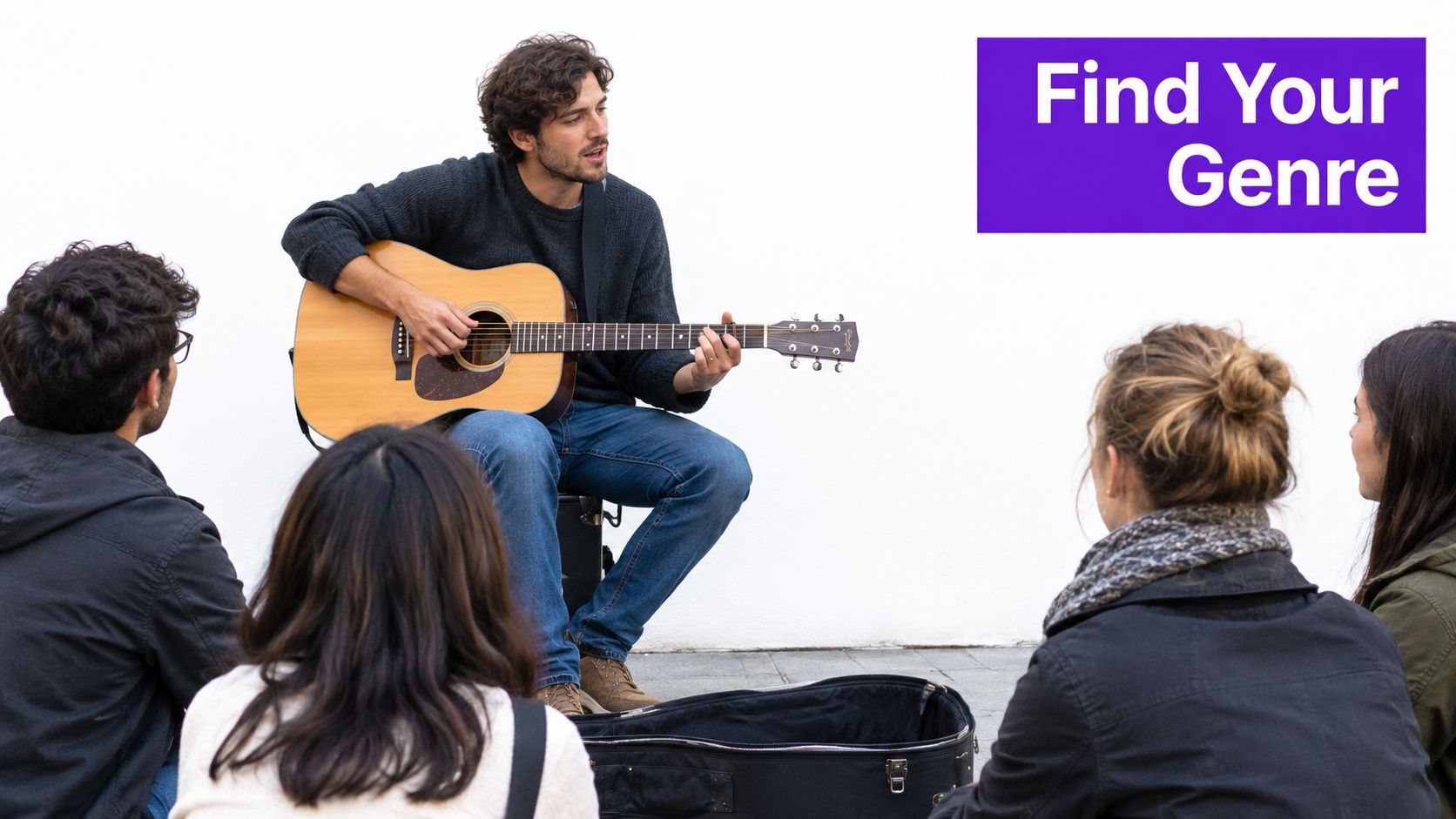 A man playing an acoustic guitar for a small group of people sitting on the ground