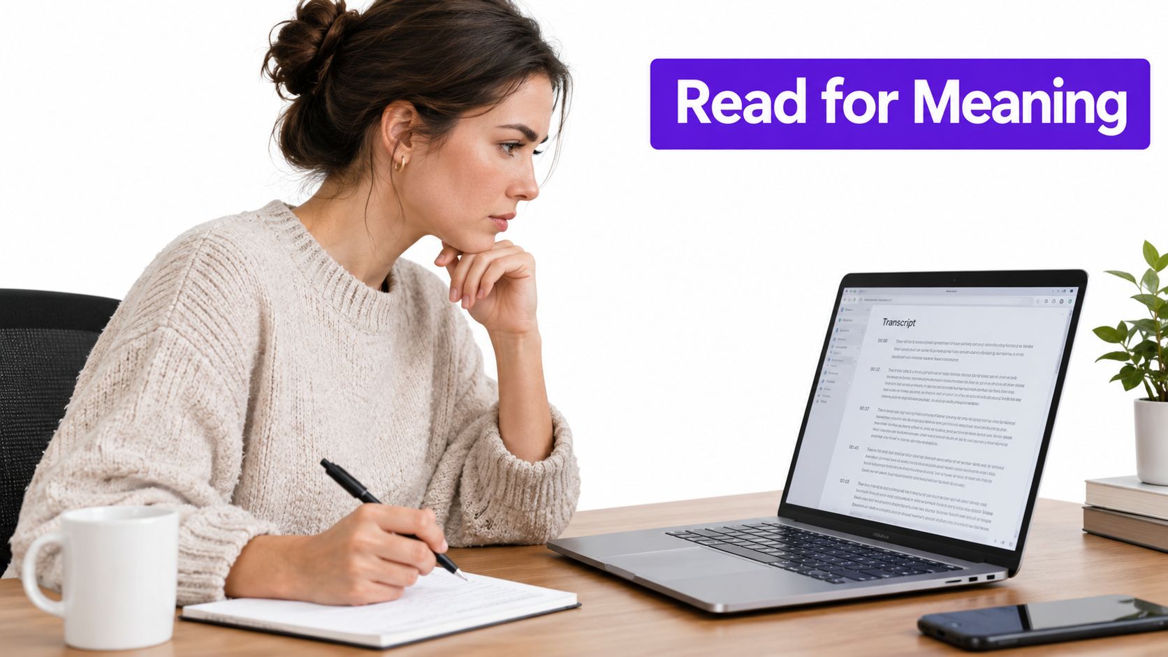 A focused woman takes notes while reading a video transcript on her laptop at a desk.