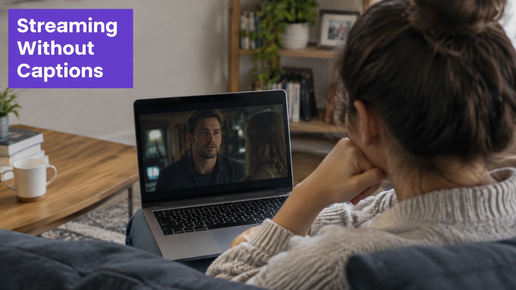 A young woman sitting on a couch watching a movie on her laptop without any subtitles enabled.