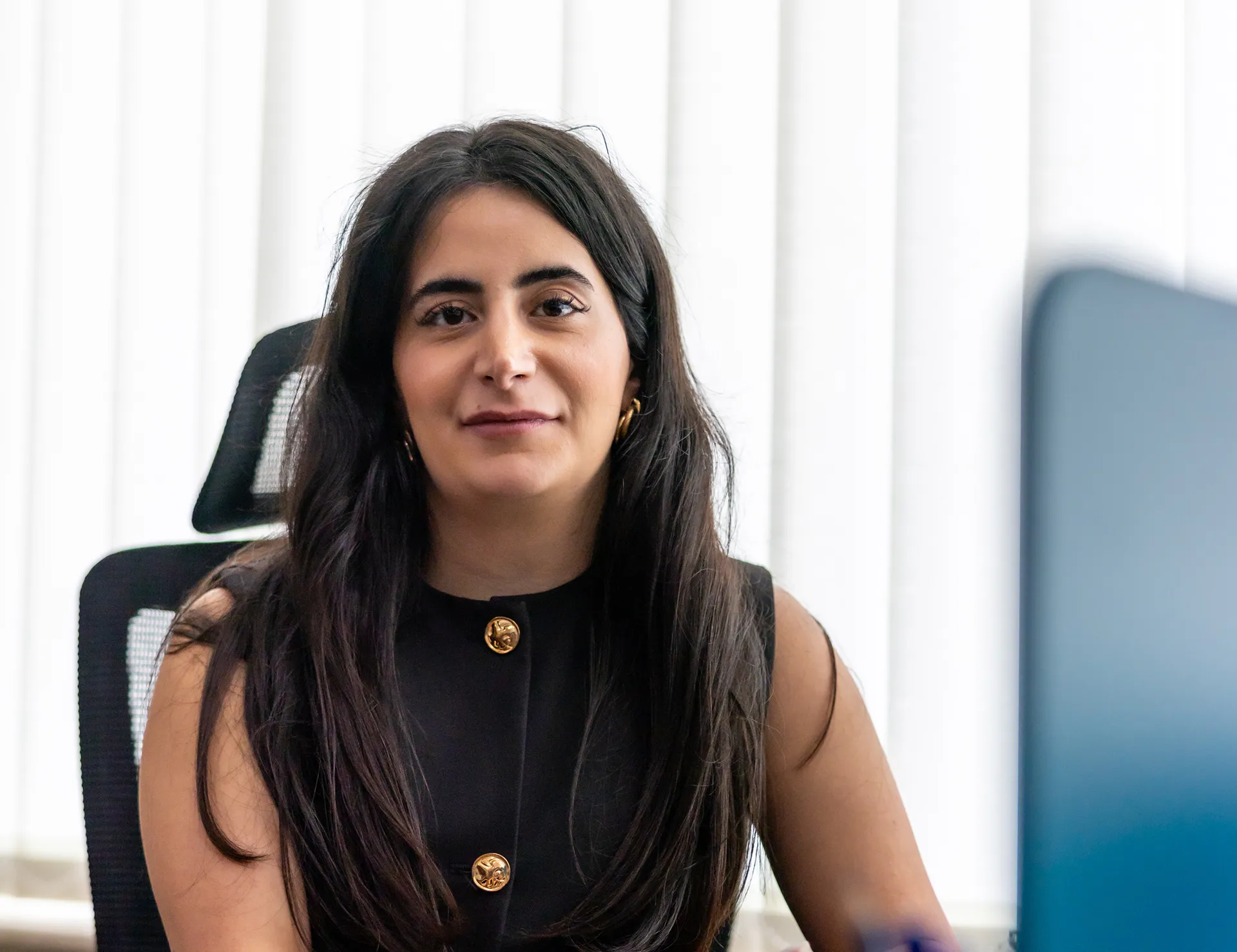 Patricia, business development lead at Kayrouz & Associates, seated during a client-focused meeting.