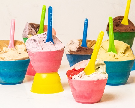 multiple colorful gelato cups with gelato in them