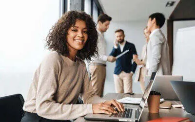 young women sitting at computer in an office 