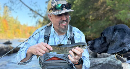 Fly angler holding a land lock, salmon Maine
