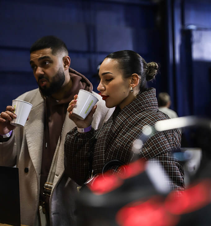 "People at the event are drinking from Shareclub cups.