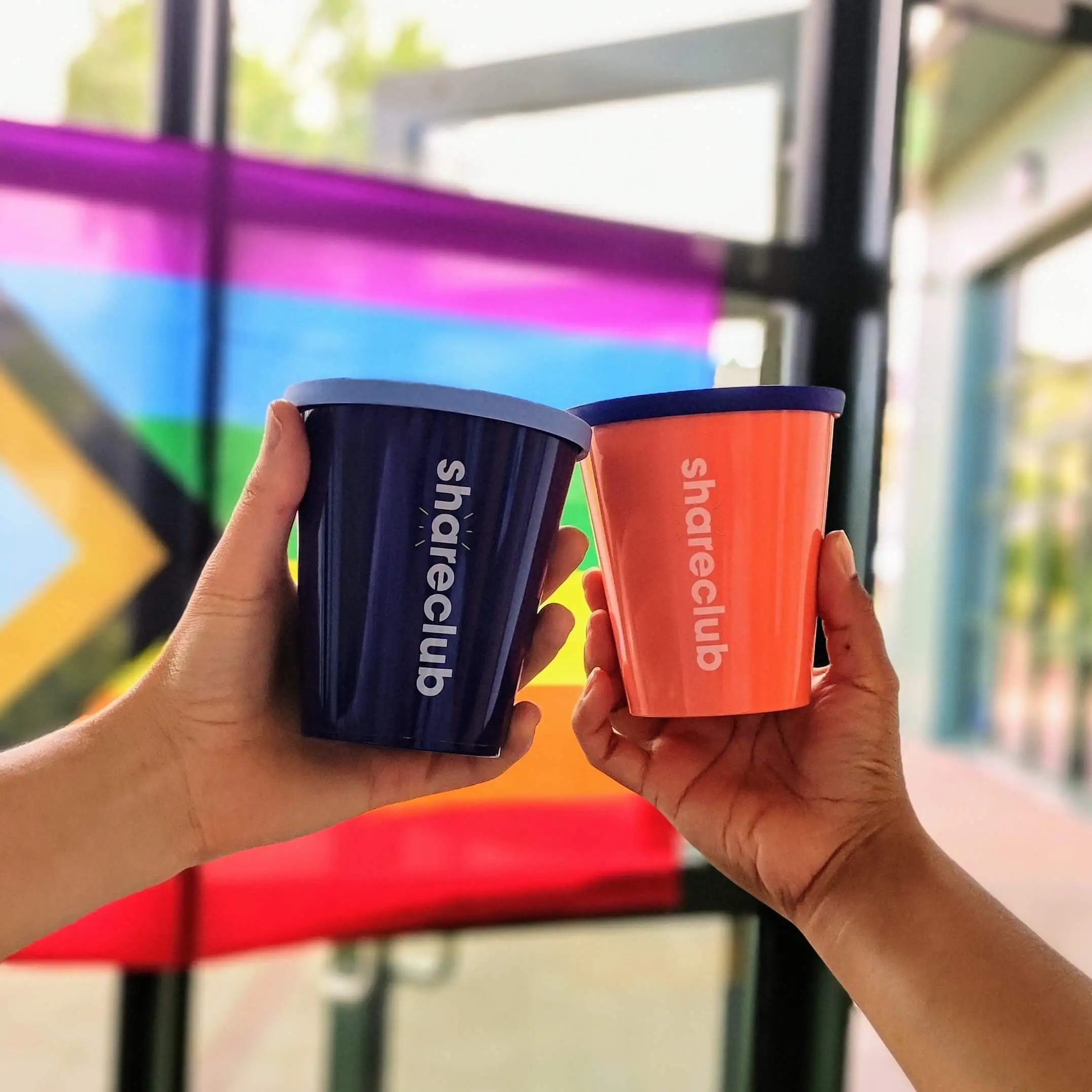 Two Shareclub reusable cups together.