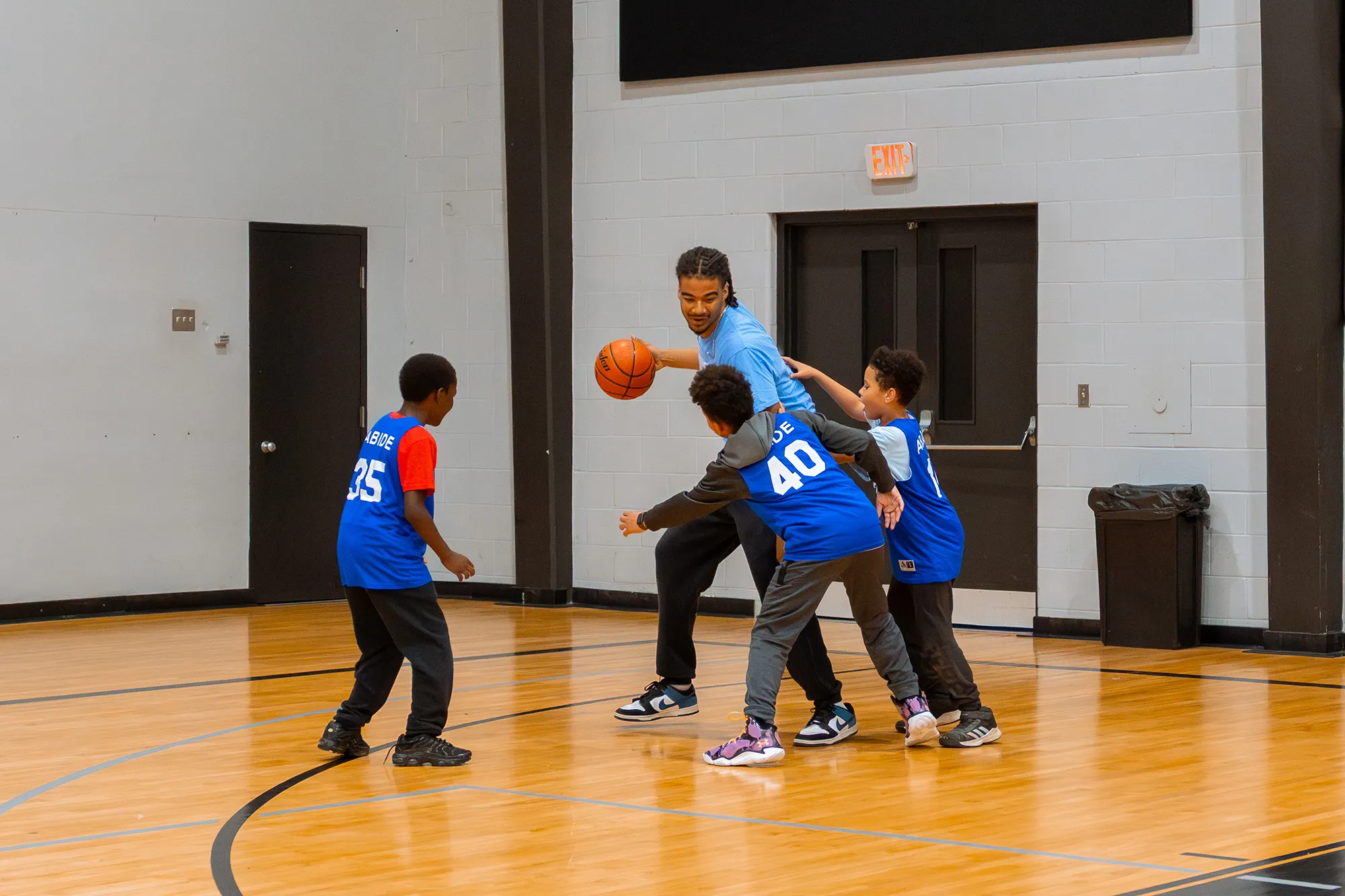 A group of young boys playing a game of basketball.