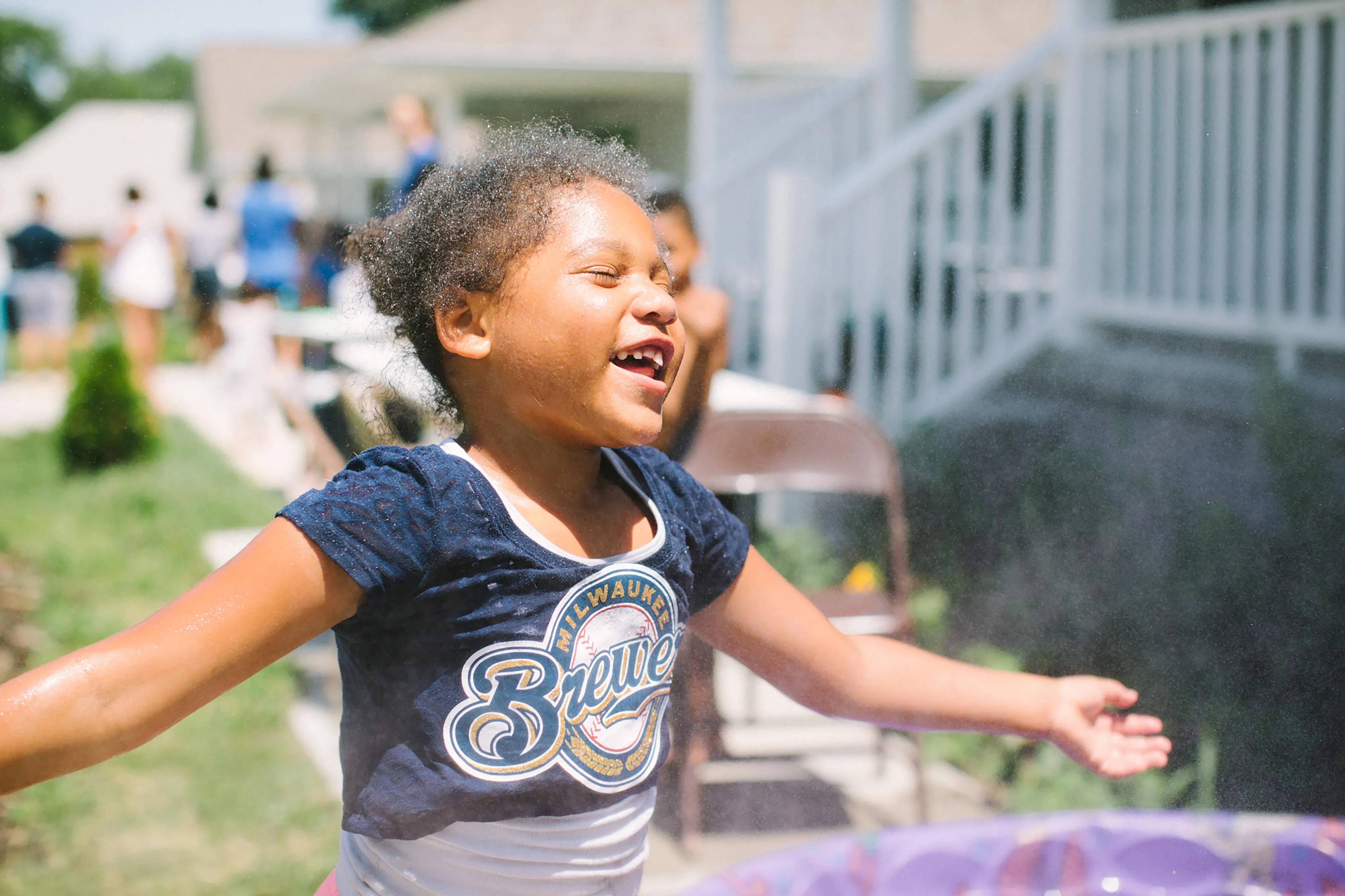 A little girl that is standing in front of a frisbee.